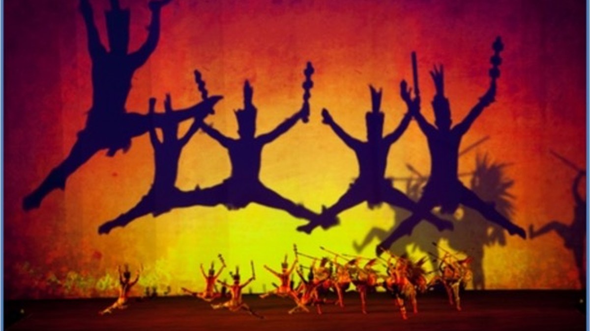 Dancers silhouetted against a vast projected backdrop at the Cinco de Mayo ceremony